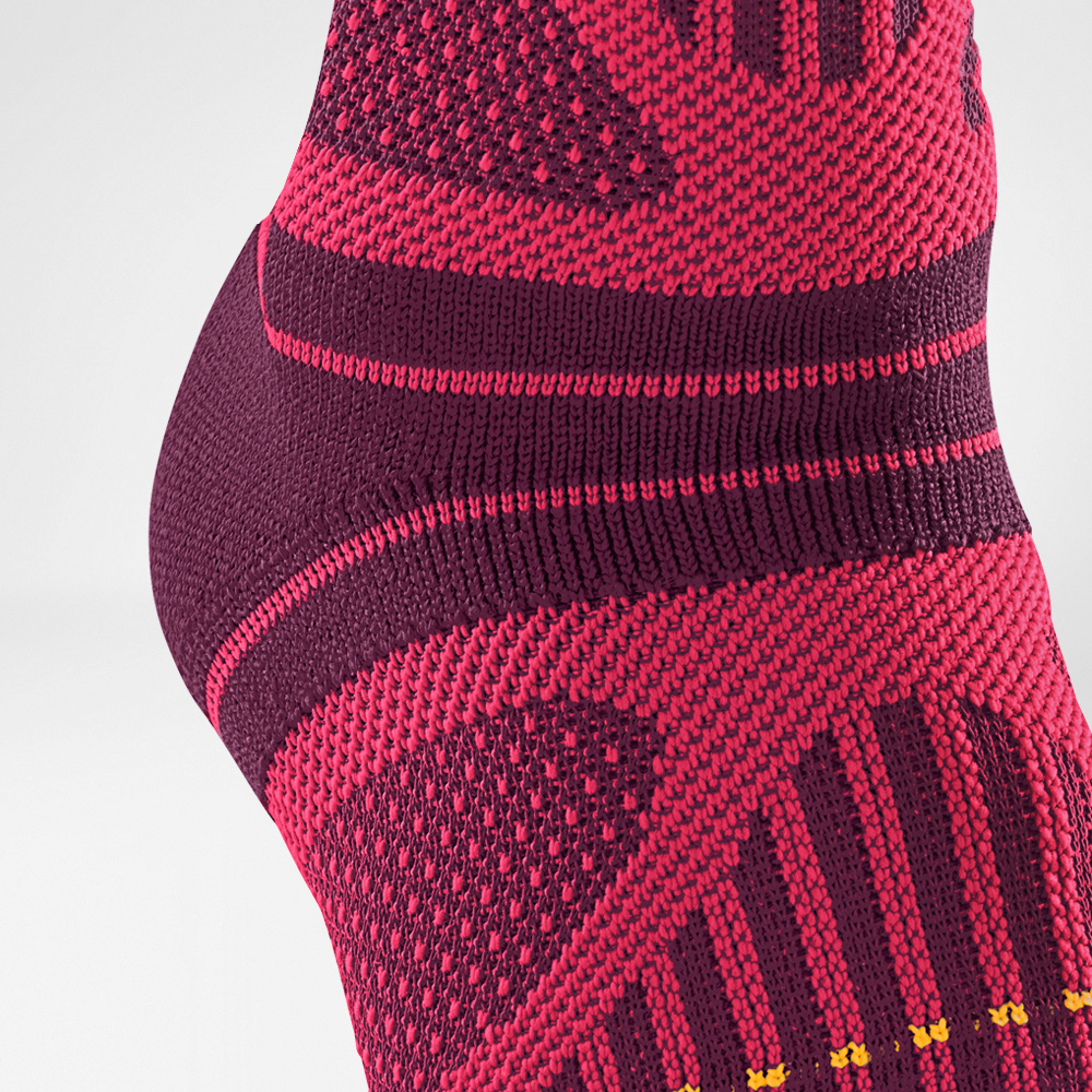 Detailed view of the knitting course of the pink sports bandage for the ankle