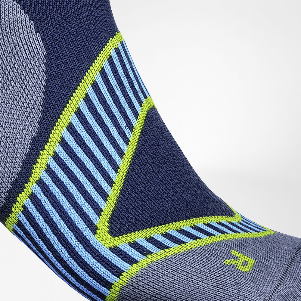 Detailed view of the ankle stabilization zone of the blue short running socks