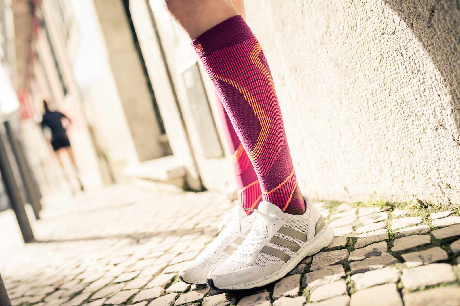 Close up of colorful running socks on the body in an urban environment