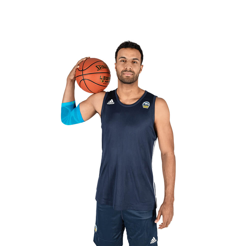 Man with basketball wears a sports leeve for the elbow