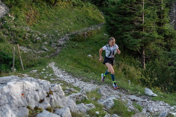 The runner has Trail Run socks and jogged over a stony, hilly terrain in the forest