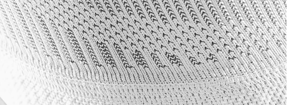 Detailed view of a white Knee Sleeves with a focus on the knitting pattern