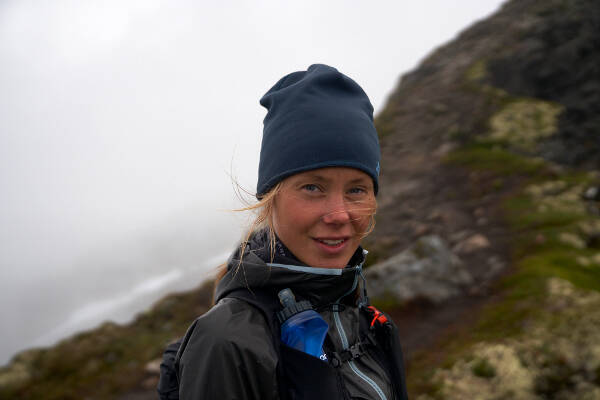 Portrait of Johanna Aström with a hat in a rough mountain landscape