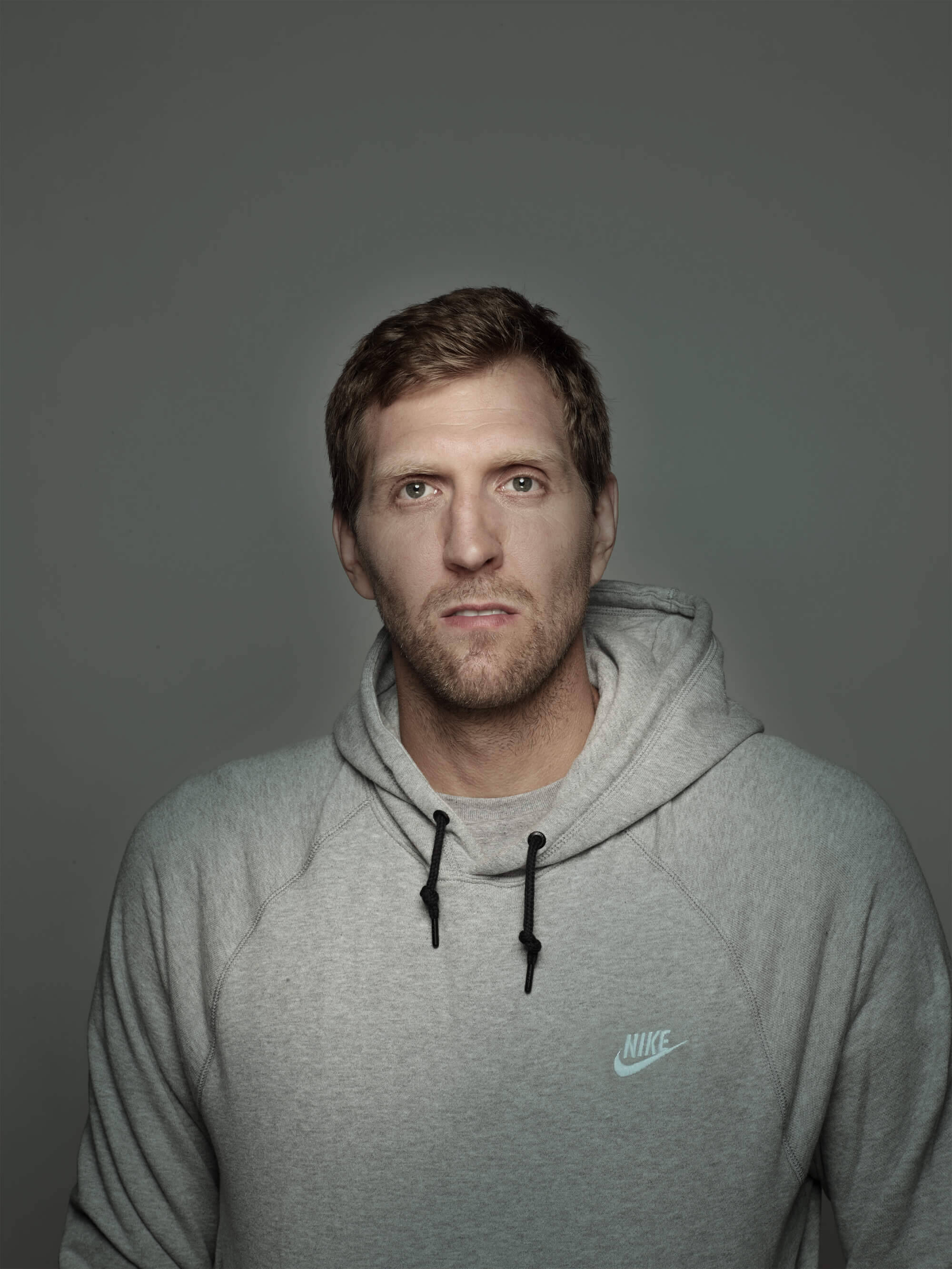 Portrait of Dirk Nowitzki in the gray hoodie against a gray background