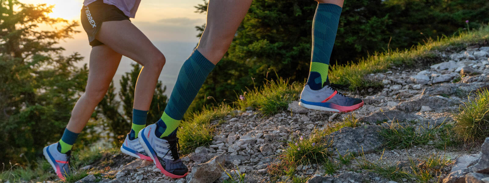Runners run up a mountain and carry Trail Run Socks