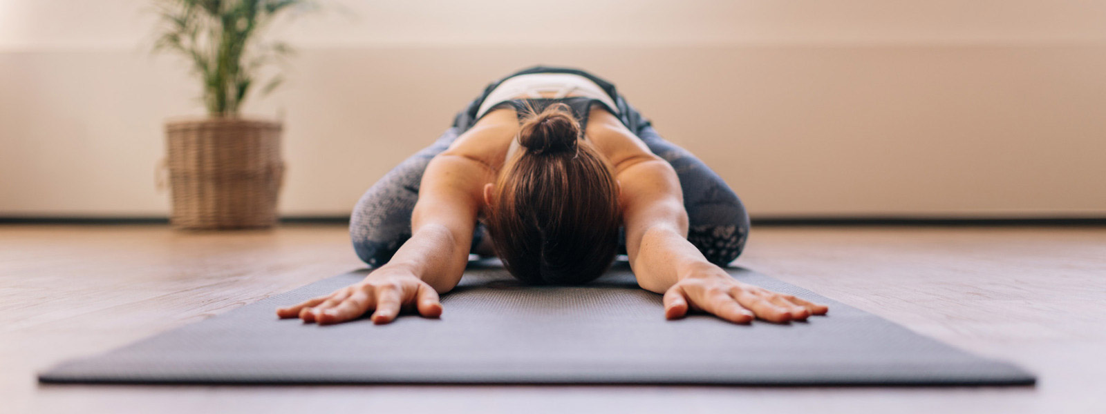Deep -relaxed woman has put her head back between her arms on the mat