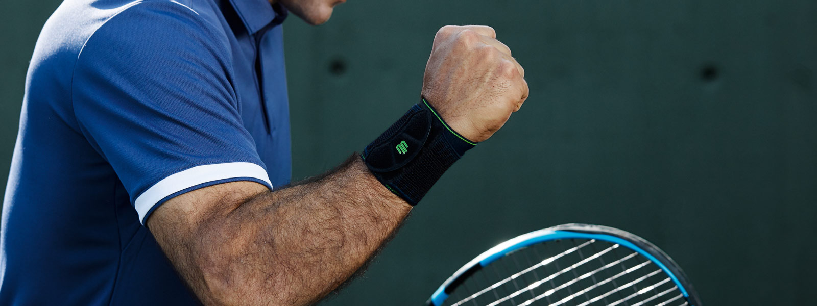 Tennis player with a black wrist bandage balls the fist