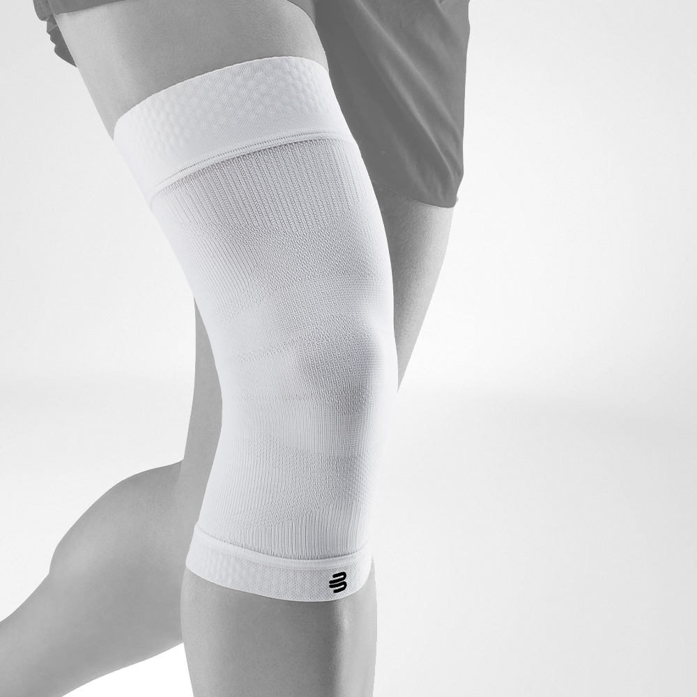 Complete view of the White Knee Sleeves on a stylized gray leg