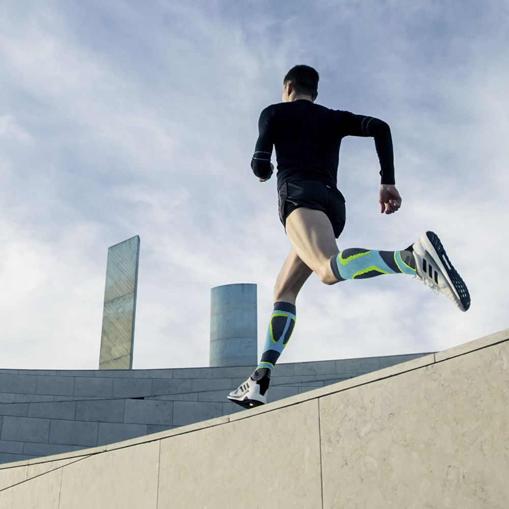 Runner with compression socks to run on a stone wall