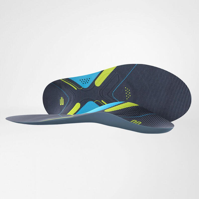 Two shoe inserts one lying down the other lying on the side next to it on gray background