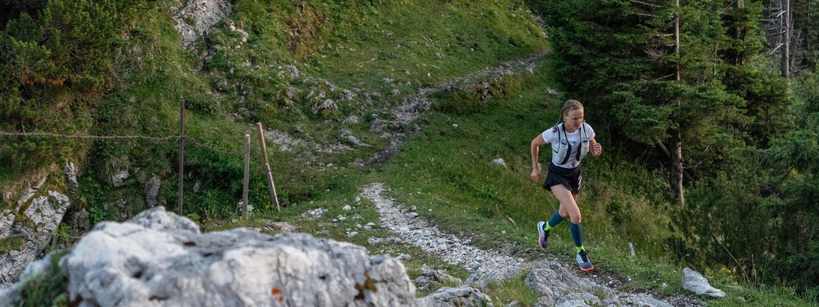 The runner has Trail Run socks and jogged over a stony, hilly terrain in the forest