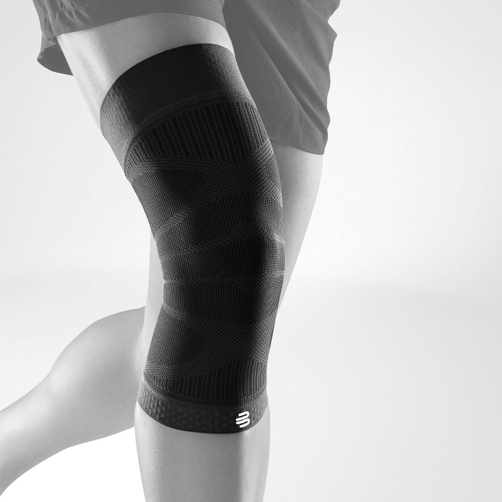 Complete view of the Black Knee Sleeves on a stylized gray leg