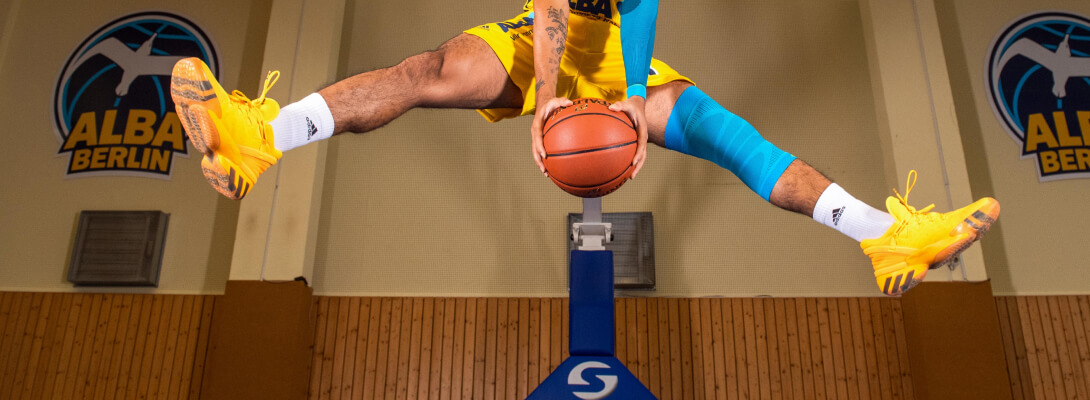 Basketball player makes a balancing act he wears a knee sleeve on the left leg