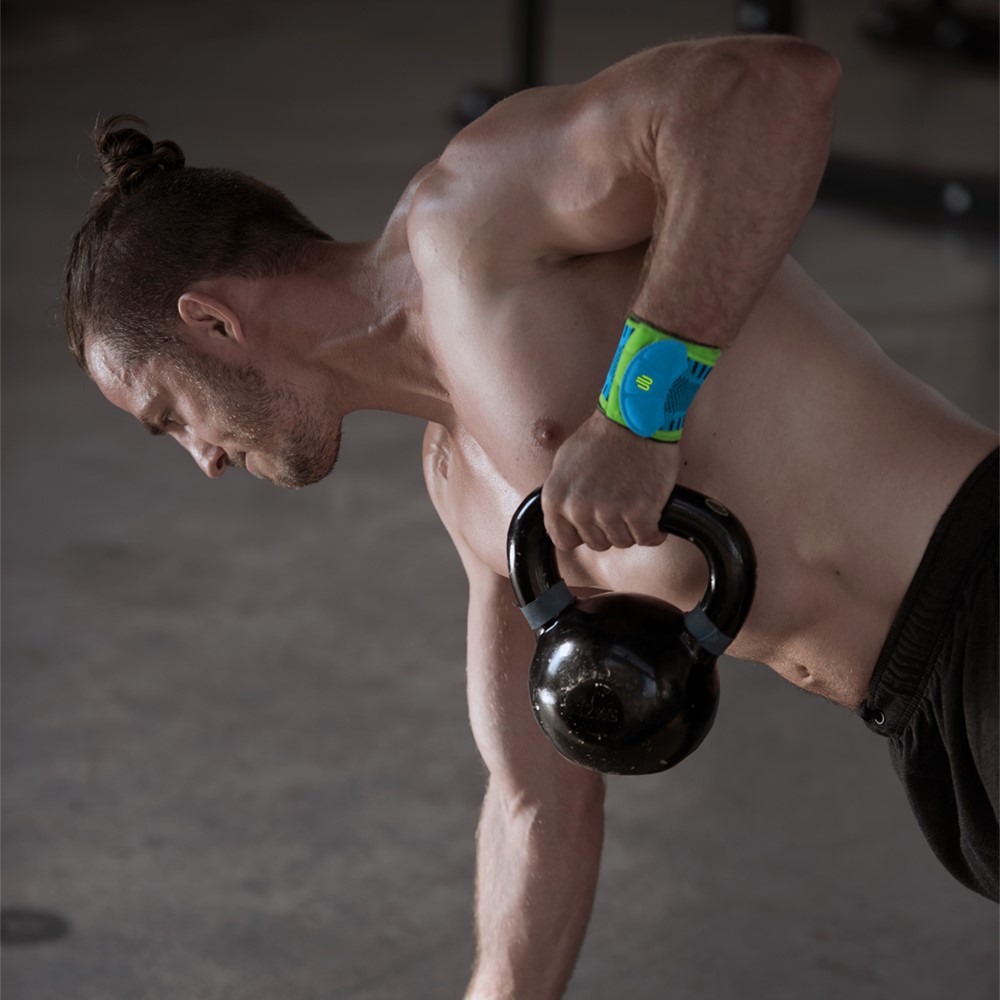Man at Kettlebell Training with wrist bandage for sport